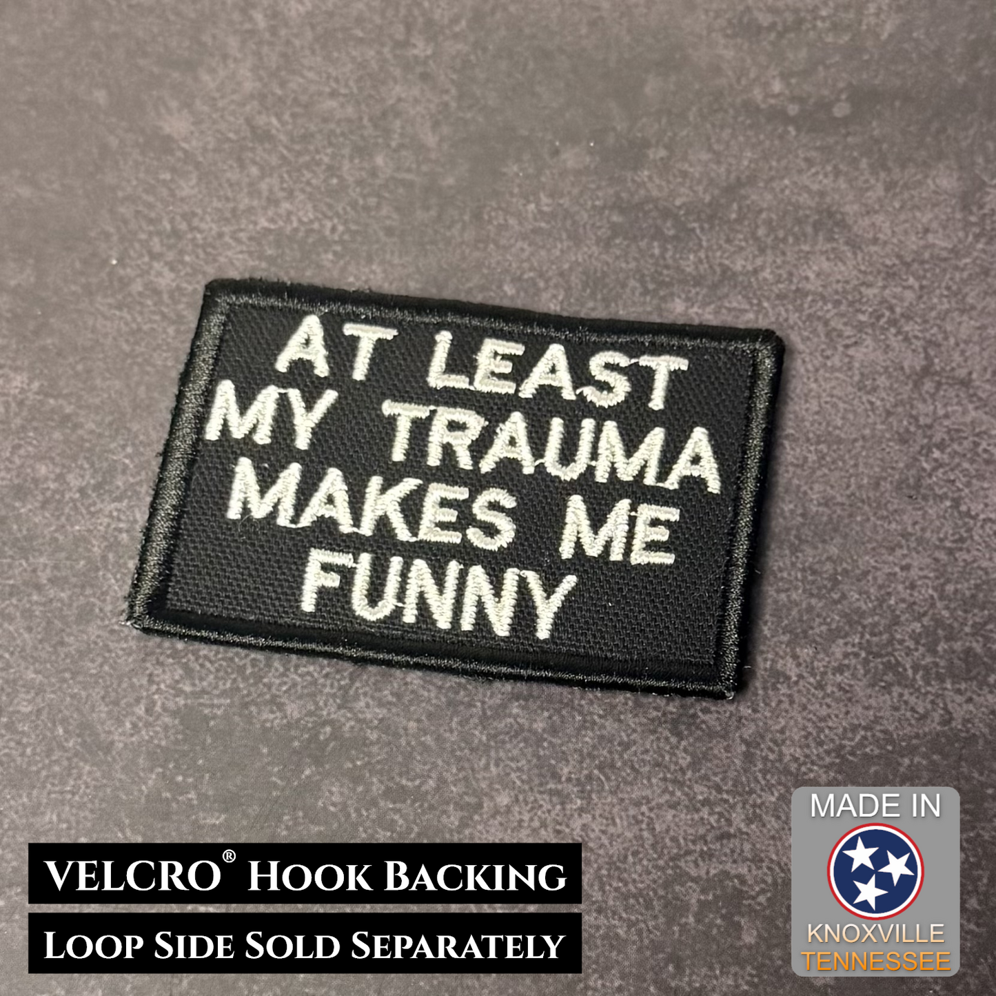 At Least My Trauma Makes Me Funny embroidered morale patch with white lettering on black background
