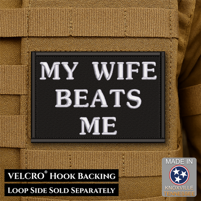 A rectangular black Velcro patch with white embroidered text reading “MY WIFE BEATS ME,” shown attached to tan tactical gear. Text at the bottom notes VELCRO hook backing and loop side sold separately; a “Made in Knoxville Tennessee” badge appears in the lower right.