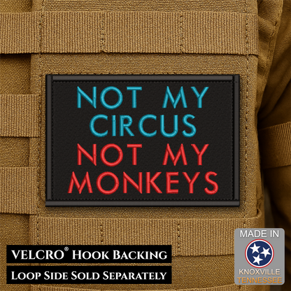 A rectangular embroidered patch with black background and the text 'NOT MY CIRCUS NOT MY MONKEYS' in blue and red lettering, shown attached to tan tactical gear. Text at the bottom reads 'VELCRO HOOK BACKING LOOP SIDE SOLD SEPARATELY,' and a 'Made in Knoxville Tennessee' badge appears in the lower right.