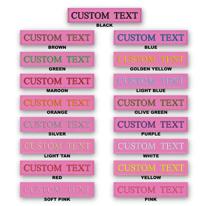 A color-options chart showing multiple rectangular labels with pink stitched borders and the words 'CUSTOM TEXT' in different text colors and backgrounds. The top header reads 'CUSTOM TEXT' and the labels below show color variants such as black, brown, green, maroon, orange, light blue, olive green, silver, purple, light tan, white, yellow, and soft pink.