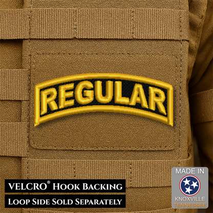 A tan embroidered military-style patch reading "REGULAR" in yellow with a black outline, shown attached to tan webbing. Text at the bottom says "VELCRO HOOK BACKING LOOP SIDE SOLD SEPARATELY," and a badge in the lower right says "MADE IN Knoxville Tennessee.