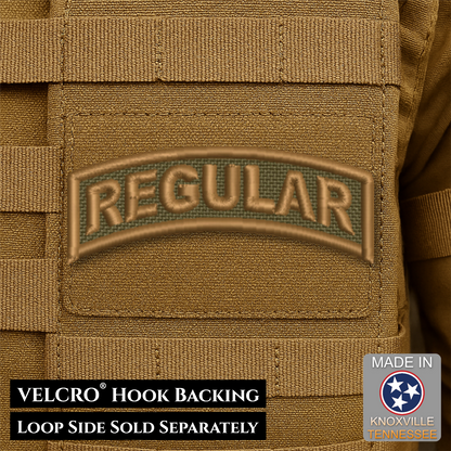 Close-up of a tan tactical vest or pouch with a sewn patch reading "REGULAR" in raised letters over a dark green mesh background. Text at the bottom says VELCRO HOOK BACKING and LOOP SIDE SOLD SEPARATELY, and a badge says MADE IN Knoxville Tennessee.