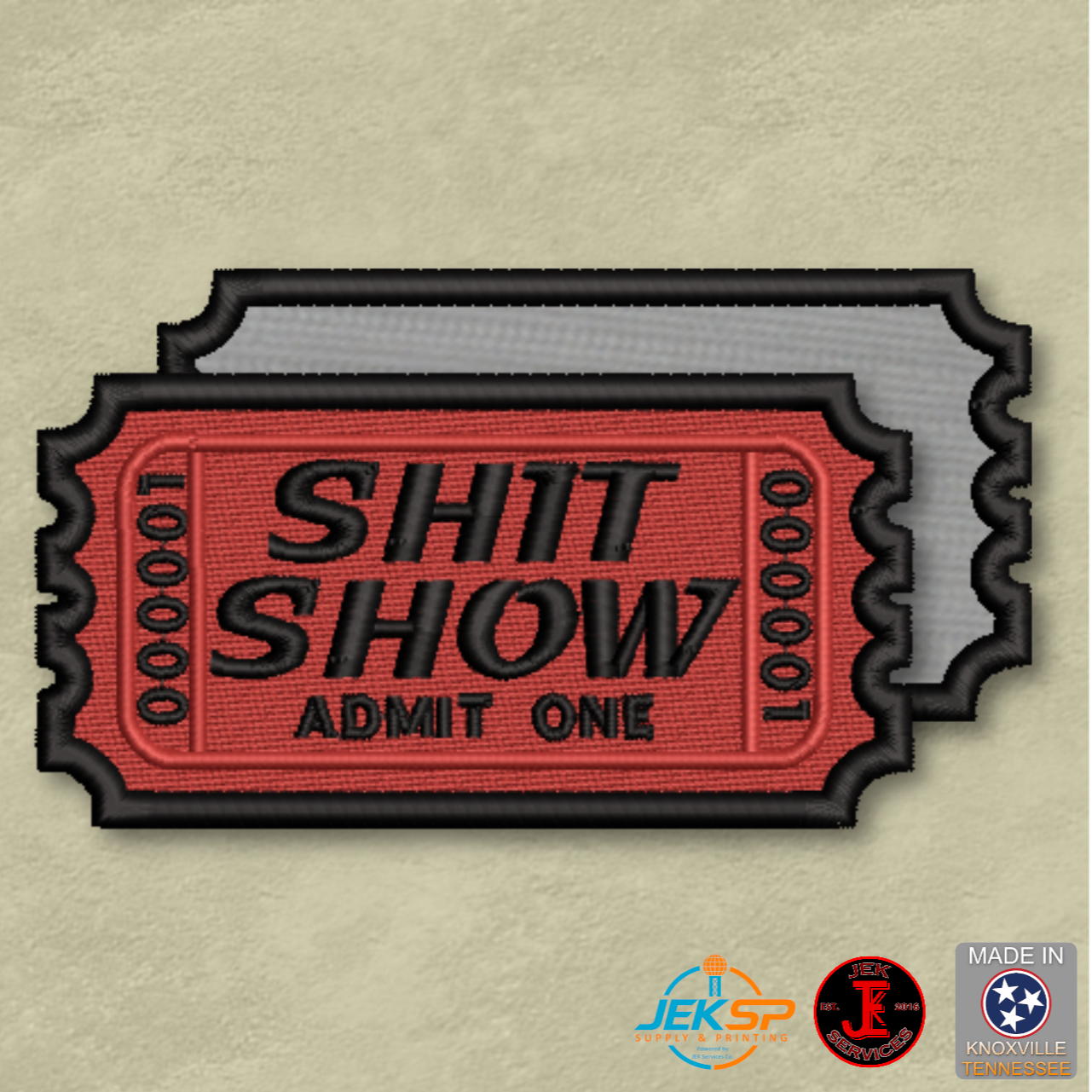 Patch with 'SHIT SHOW ADMIT ONE' text on a beige background