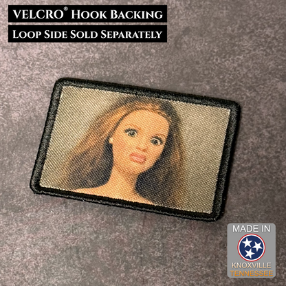 Morale patch with a doll ew face design on a gray background, featuring VELCRO hook backing