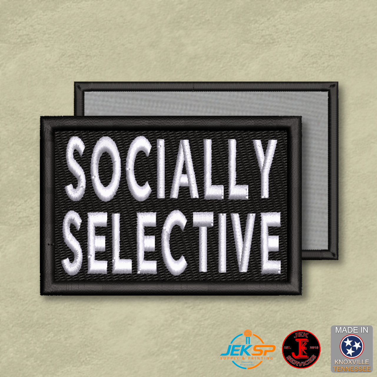 Socially Selective embroidered funny introvert morale patch with white lettering on black fabric, genuine hook backing, and gray loop panel displayed behind.