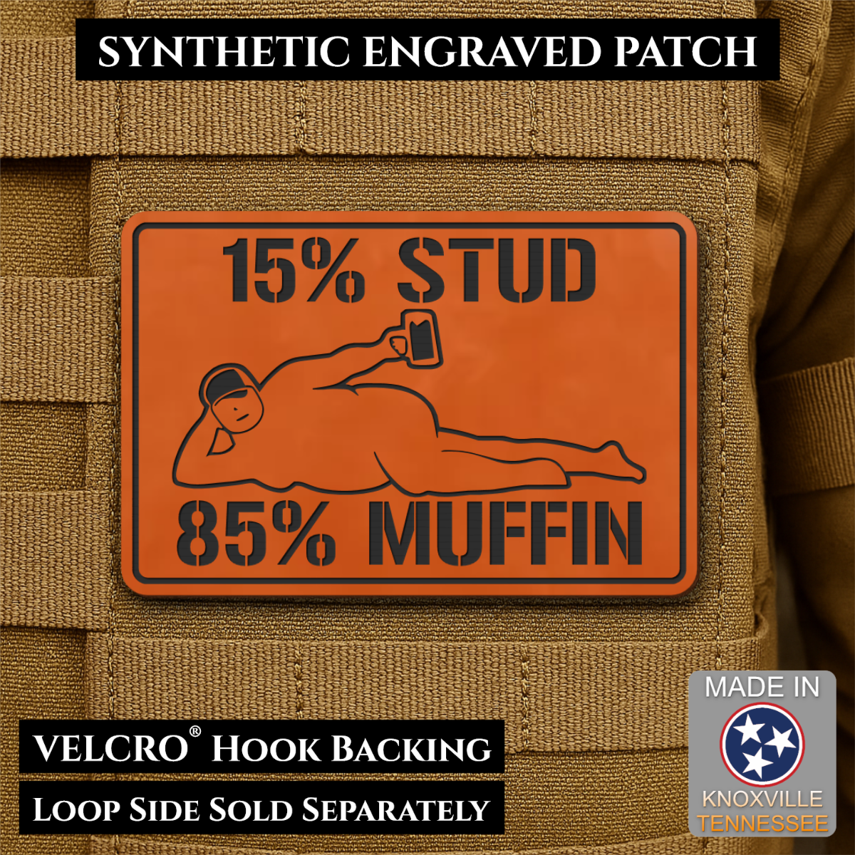 15% Stud 85% Muffin Funny Dad Bod laser-engraved synthetic morale patch: an orange rectangular synthetic patch with black engraved text reading “15% STUD 85% MUFFIN” and a black line drawing, shown attached to tan tactical fabric.