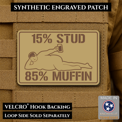 15% Stud 85% Muffin Funny Dad Bod laser-engraved synthetic morale patch: a rectangular tan synthetic PVC patch with dark brown engraved text reading '15% STUD 85% MUFFIN' and a simple figure graphic, shown attached to tan tactical.