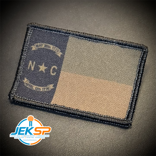 A rectangular embroidered tactical patch featuring the Navy United States Coast Guard flag design, shown on a dark textured background with a JEKSP watermark in the lower-left corner.