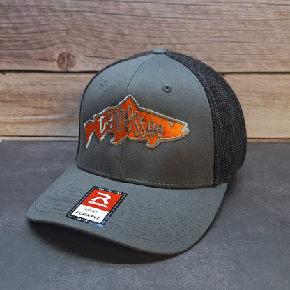 Gray cap with orange fish logo and brand label on a wooden background