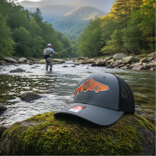 Fishing cap on a rock with a river and mountains in the background