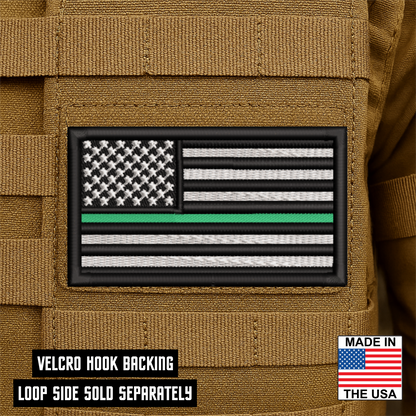 Thin Green Line American Flag embroidered tactical morale patch with hook backing attached to tactical vest