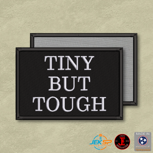 Tiny But Tough embroidered morale patch with white lettering on a black background, genuine hook-backed tactical patch made in Tennessee.