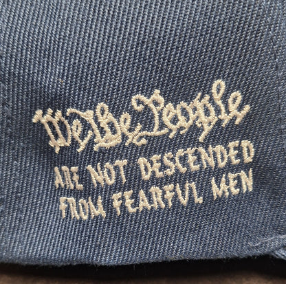 We the People text on a denim fabric background