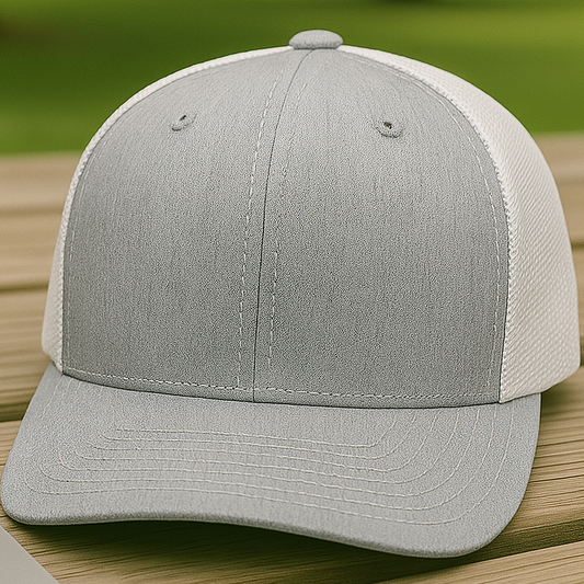 Gray and white cap on a wooden surface with a blurred green outdoor background